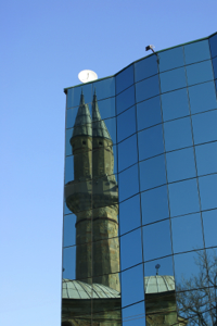 Photo credit: Prishtina, Kosovo: The Carshi Mosque is reflected in the windows of a modern office building in Kosovo's capital city. © 2007 Dave Long - Agency iStockPhoto.